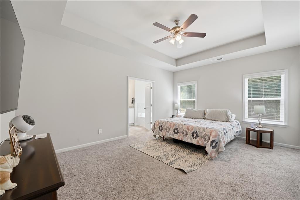 1269 Covered Bridge Road Covington, GA 30016 - Photo 15 of 31 a spacious bedroom with a bed and a window