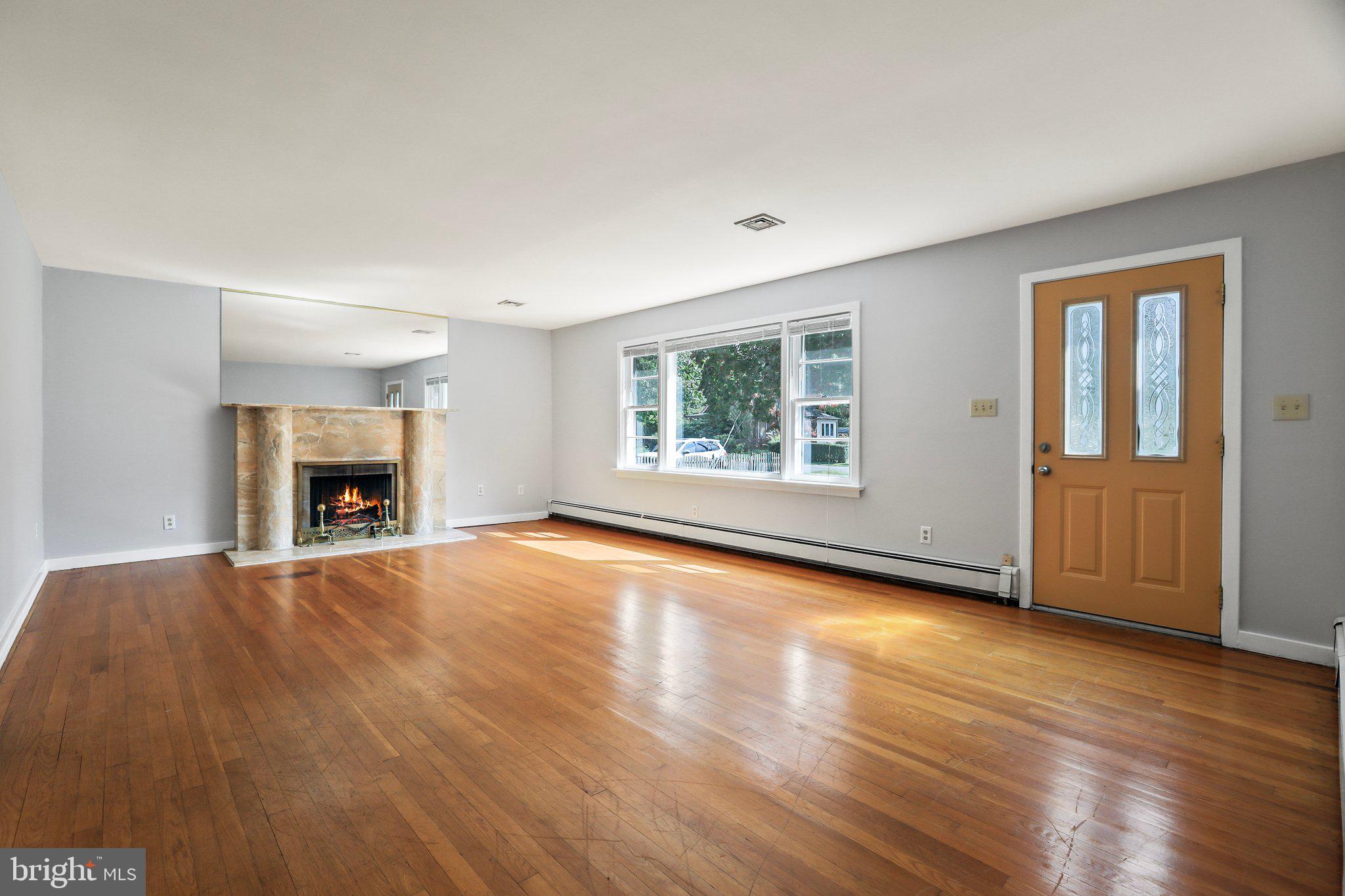 120 West Upper Ferry Road Ewing, NJ 08628 - Photo 5 of 27 an empty room with wooden floor fireplace and windows
