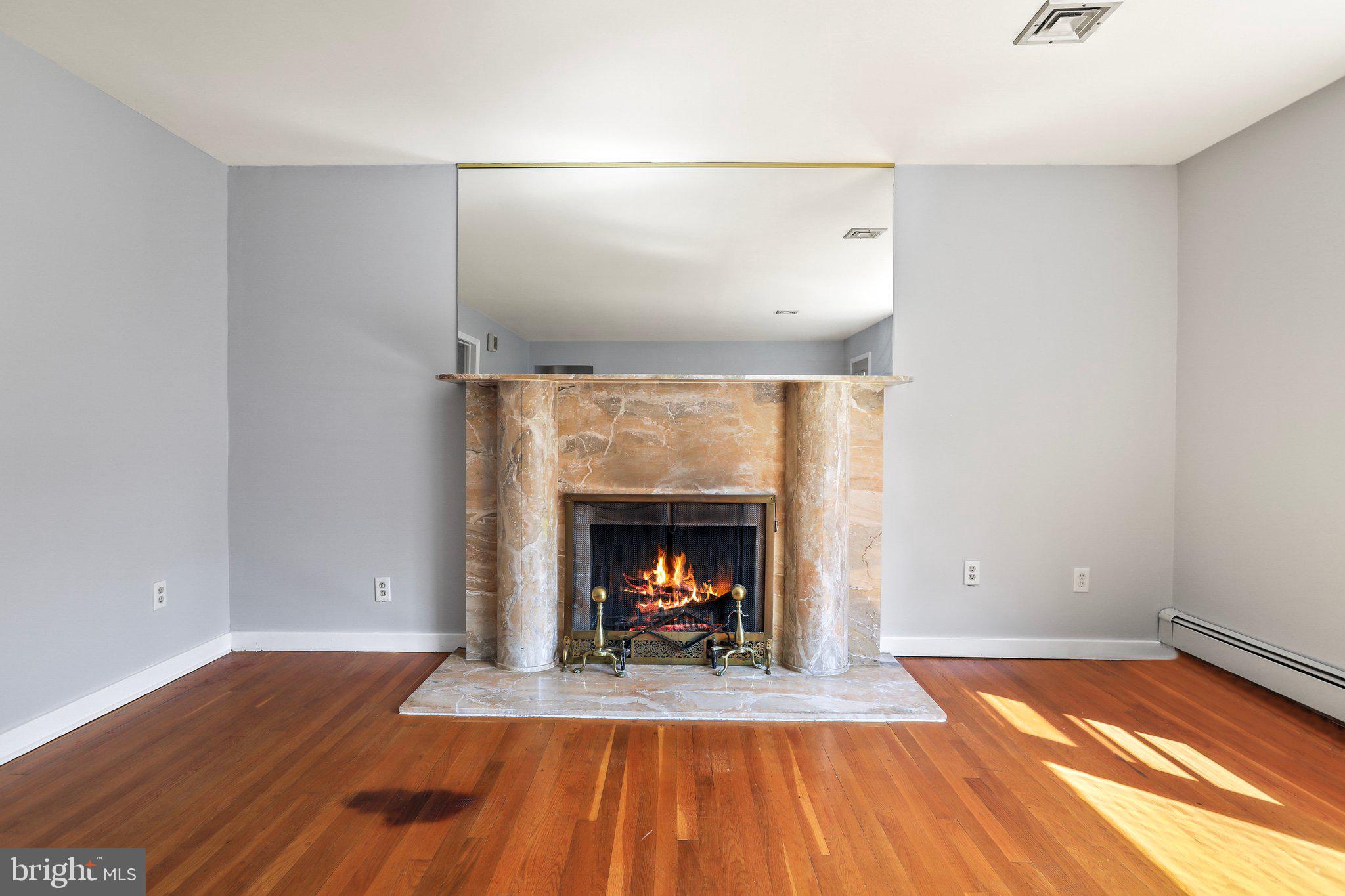 120 West Upper Ferry Road Ewing, NJ 08628 - Photo 7 of 27 a view of a livingroom with wooden floor a fireplace and window