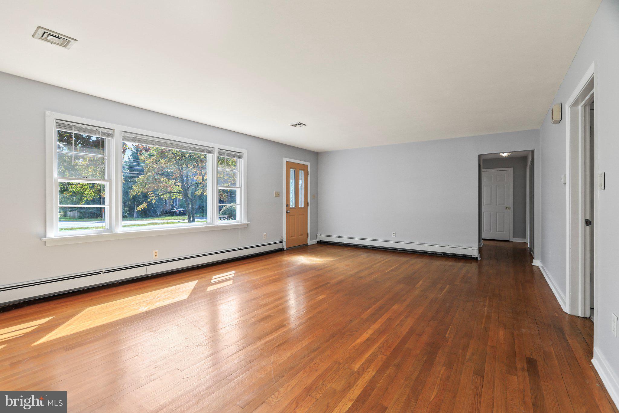 120 West Upper Ferry Road Ewing, NJ 08628 - Photo 8 of 27 a view of an empty room with wooden floor and a window