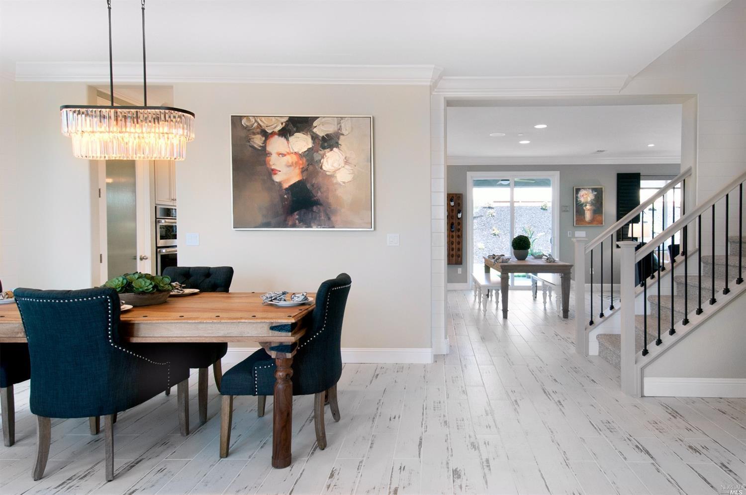 a view of a dining room with furniture wooden floor and chandelier