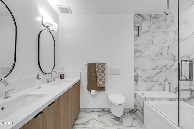 a bathroom with a toilet sink and tub