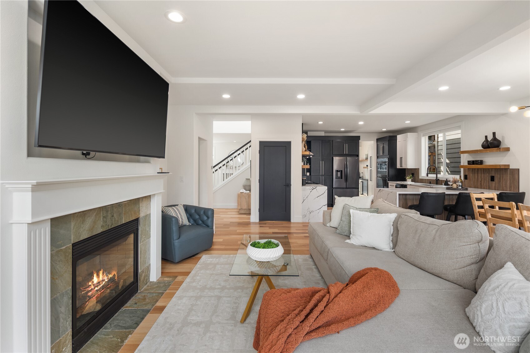 11127 Northeast 162nd Street Bothell, WA 98011 - Photo 12 of 40 a living room with furniture a flat screen tv and a fireplace