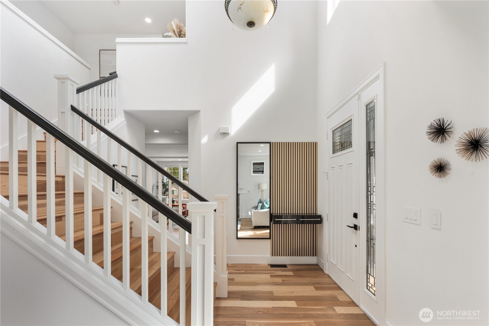 11127 Northeast 162nd Street Bothell, WA 98011 - Photo 3 of 40 a view of a hallway with wooden floor and staircase