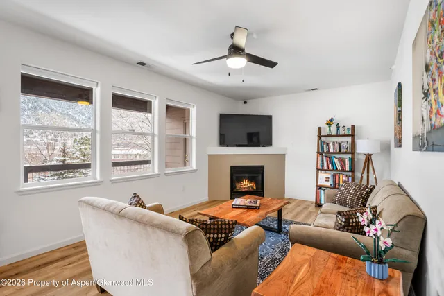 a living room with furniture fireplace and a window