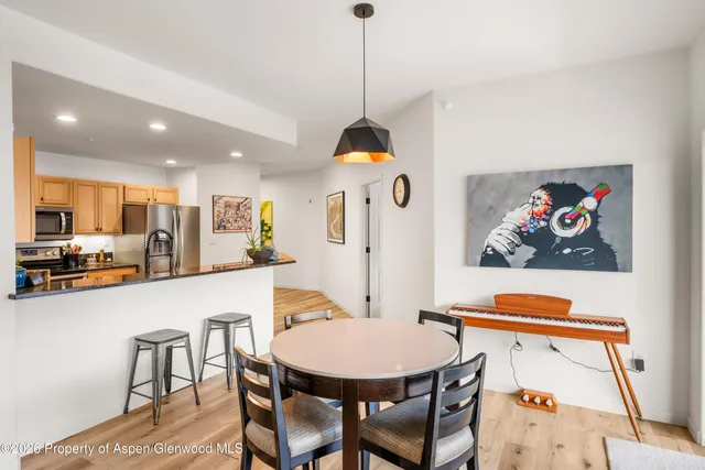 a living room with dining table furniture and a window
