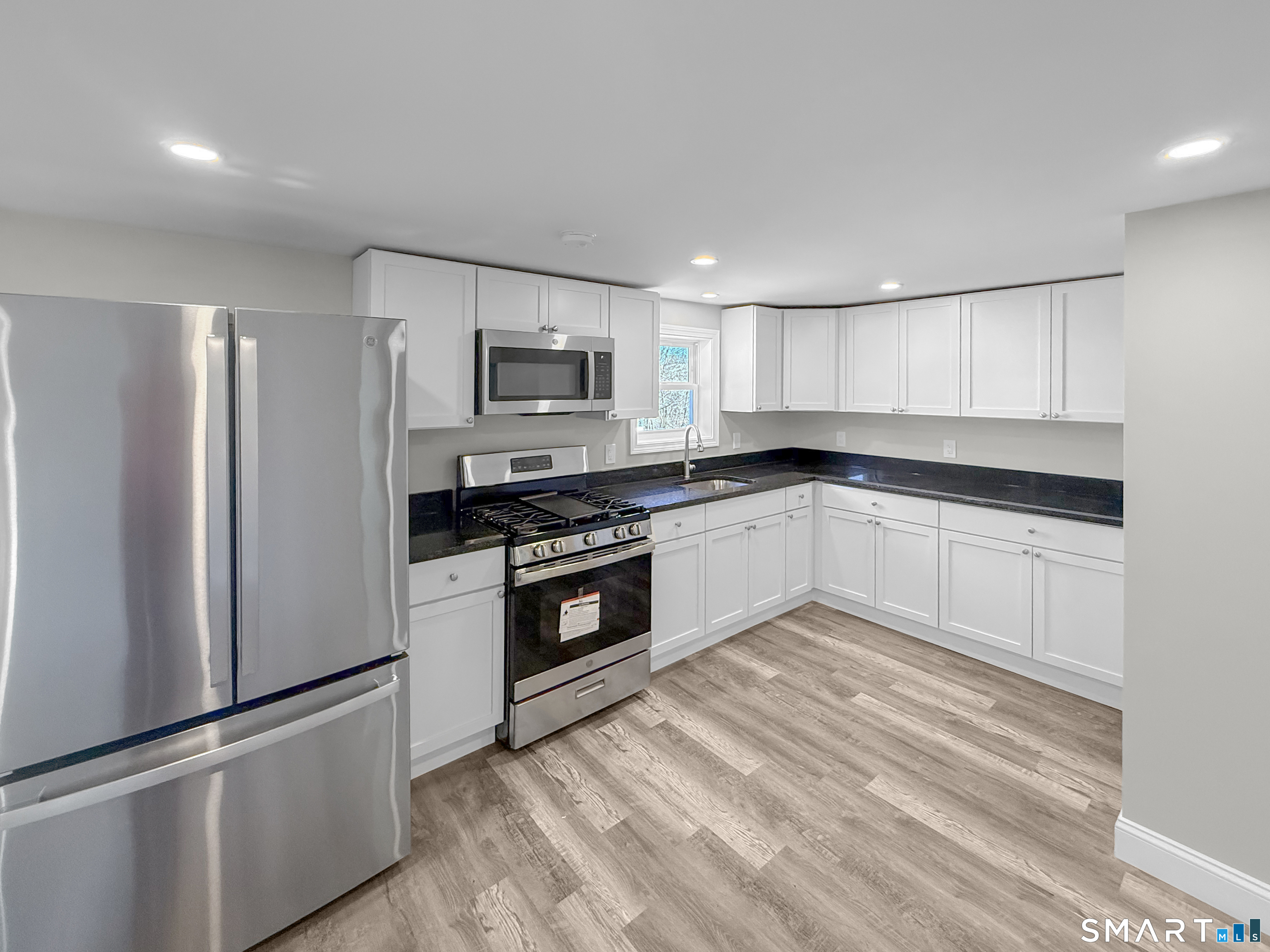 4 River Road, Unit 1 Lisbon, CT 06351 - Photo 2 of 16 a kitchen with cabinets stainless steel appliances and a window