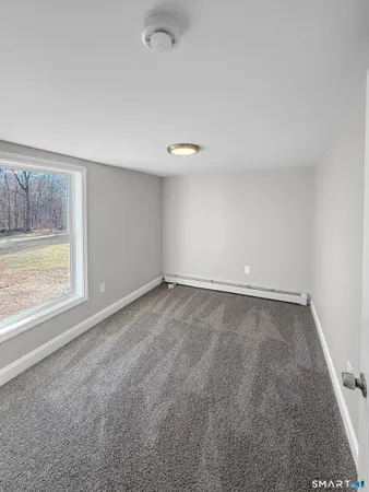 an empty room with windows and closet