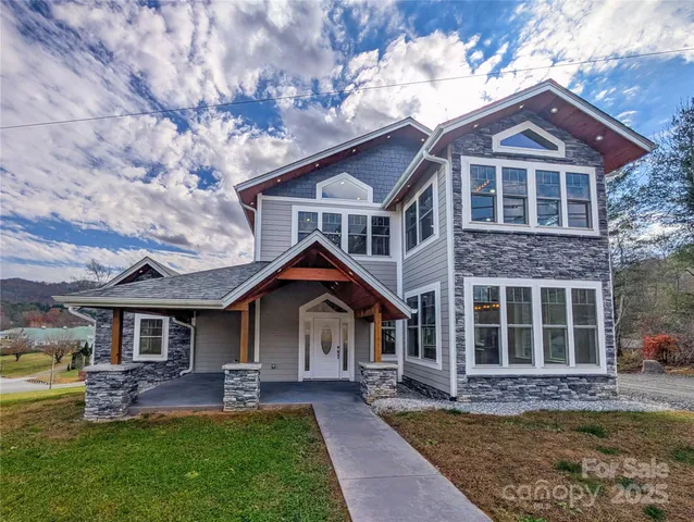 a front view of a house with a garden and patio