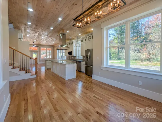 a view of kitchen with cabinets and wooden floor