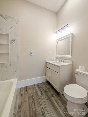 a bathroom with a sink a toilet and bathtub