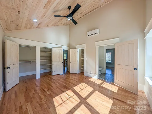 a view of a room with wooden floor and ceiling fan