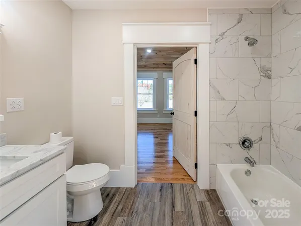a bathroom with a sink a toilet and bathtub