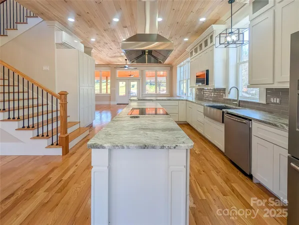 a kitchen with center island and stainless steel appliances