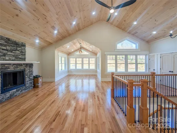 an entryway with hallway a wooden floor and a fireplace