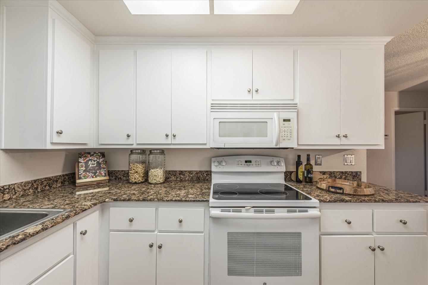 1726 Merrill Loop San Jose, CA 95124 - Photo 15 of 41 a kitchen with granite countertop white cabinets and white appliances
