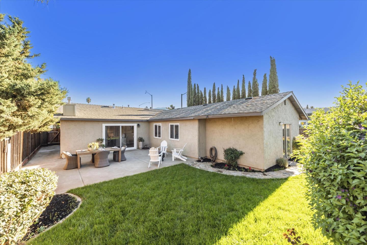 1726 Merrill Loop San Jose, CA 95124 - Photo 31 of 41 a view of a backyard with table and chairs potted plants and a large tree