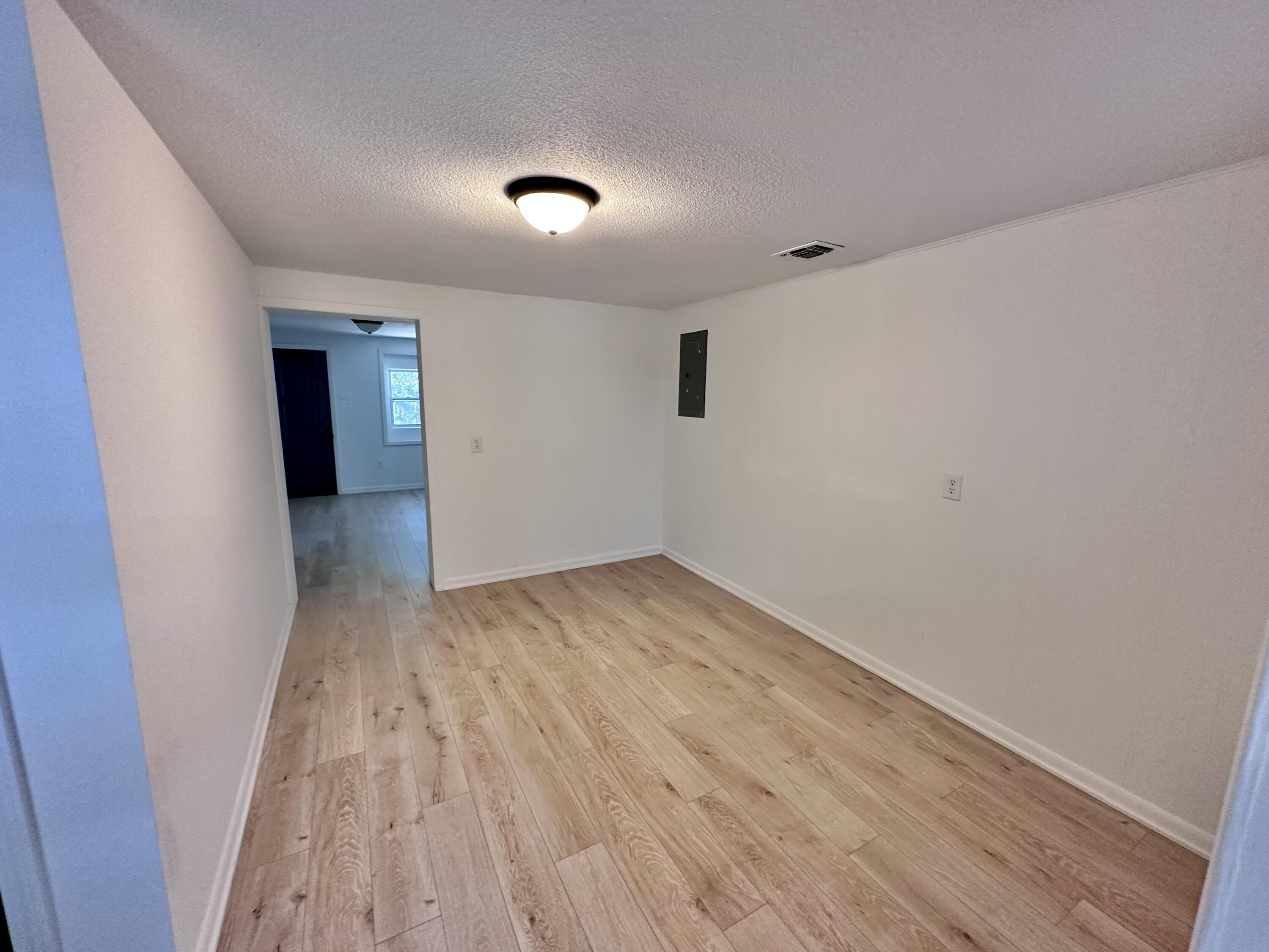 159 Smith Street Crestview, FL 32539 - Photo 13 of 29 a view of empty room with wooden floor