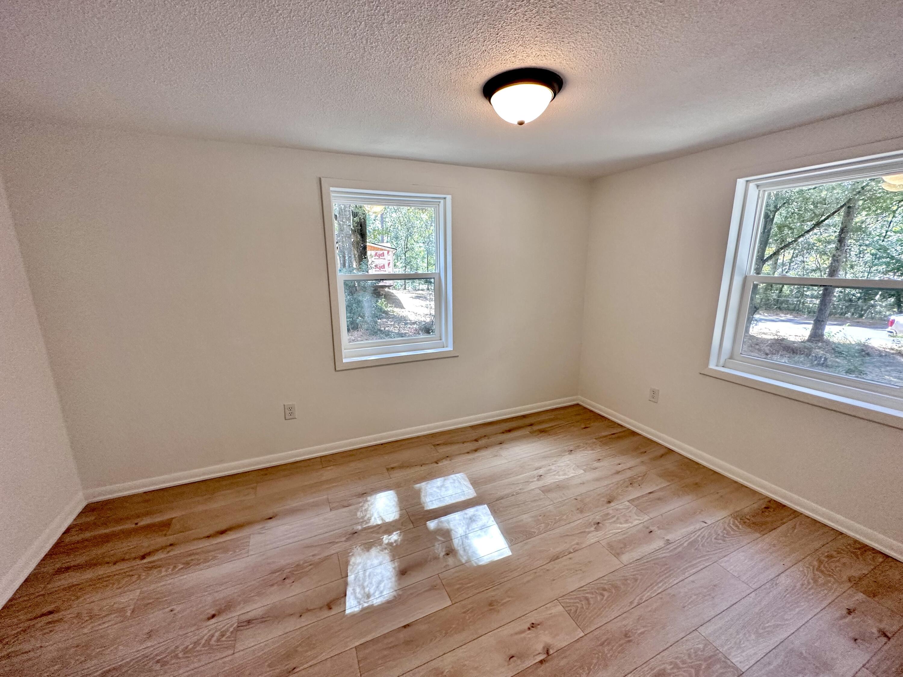 159 Smith Street Crestview, FL 32539 - Photo 16 of 29 a view of empty room with wooden floor and fan
