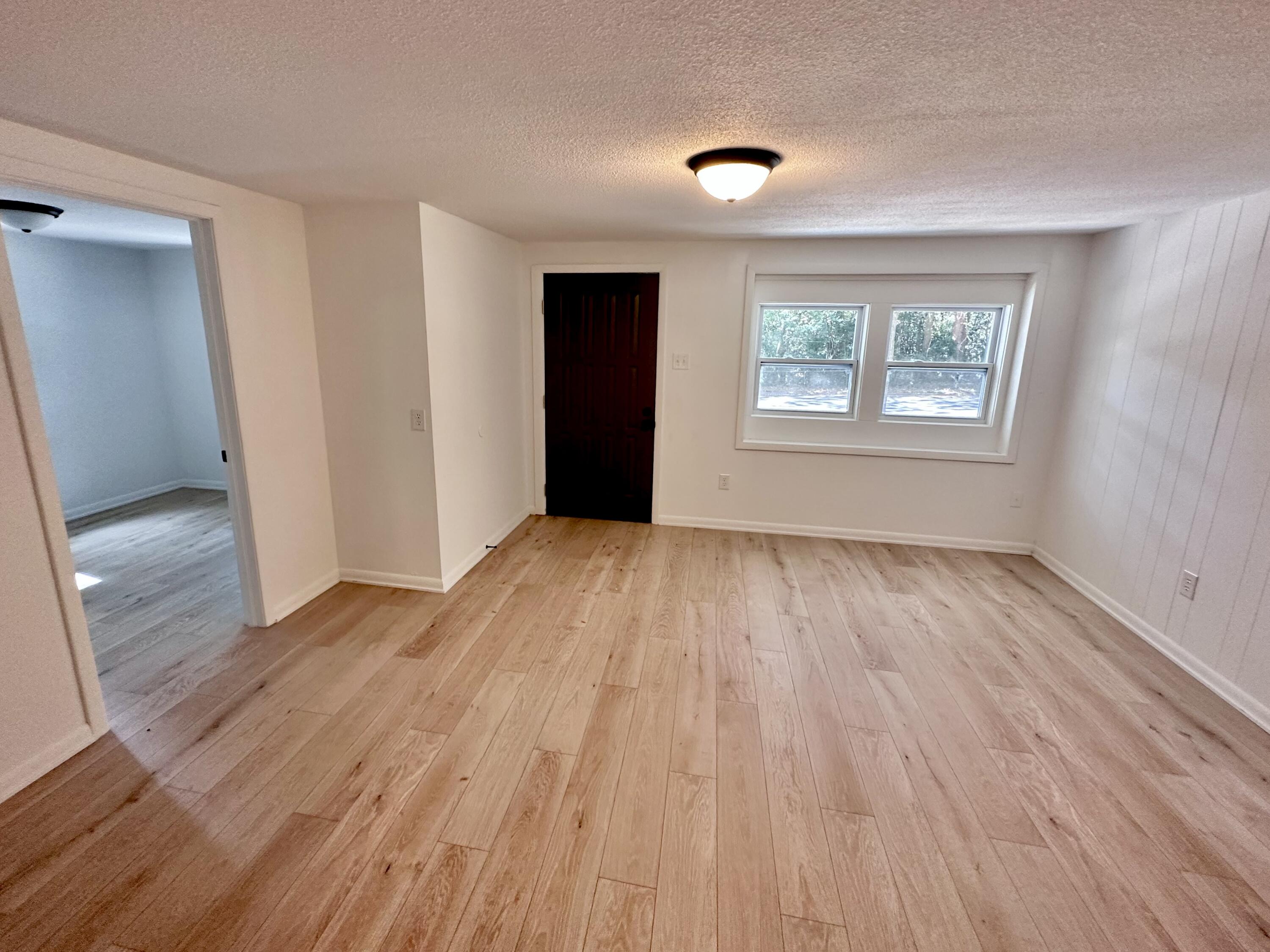 159 Smith Street Crestview, FL 32539 - Photo 19 of 29 an empty room with wooden floor and windows