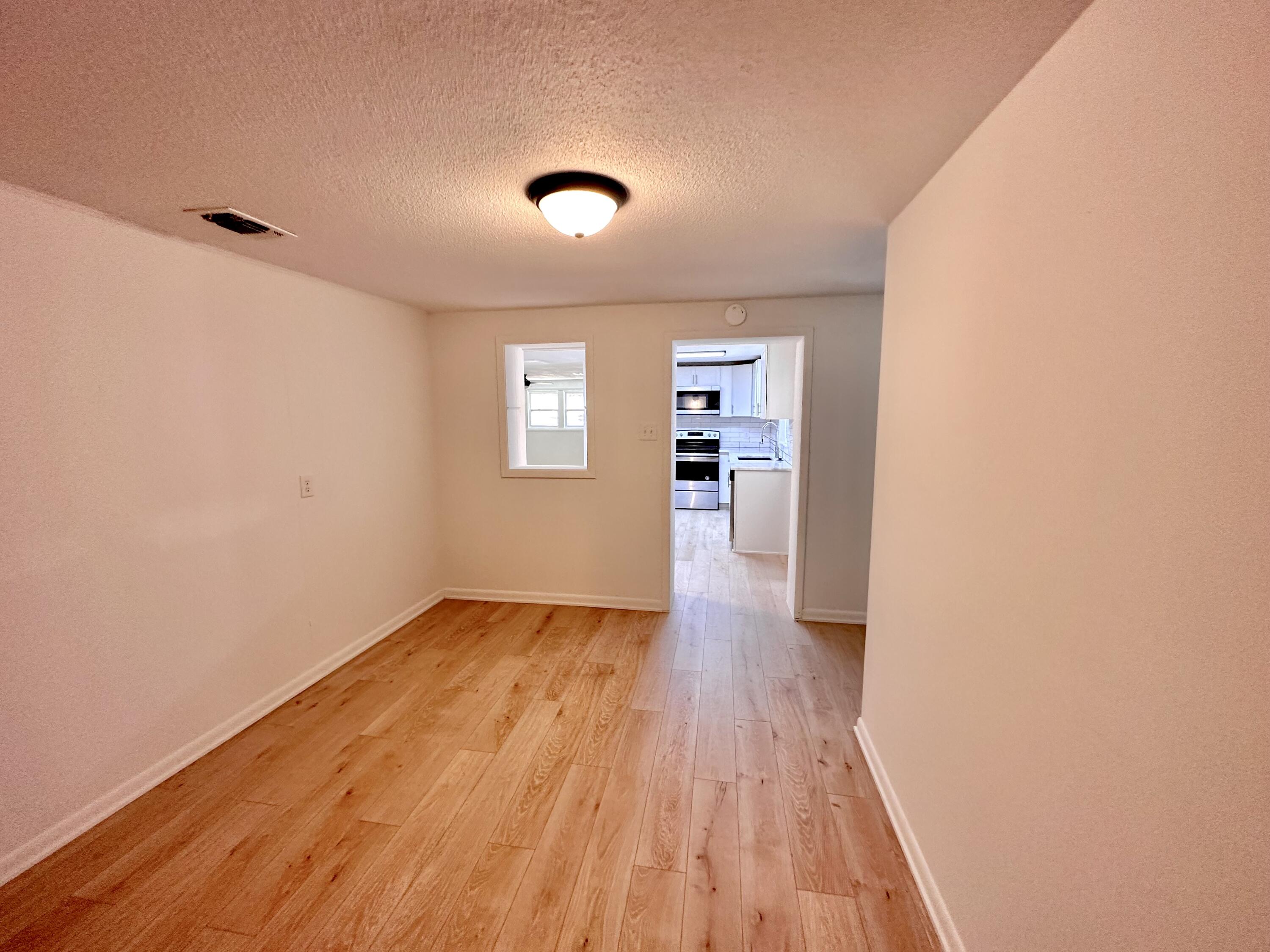 159 Smith Street Crestview, FL 32539 - Photo 20 of 29 an empty room with wooden floor and windows
