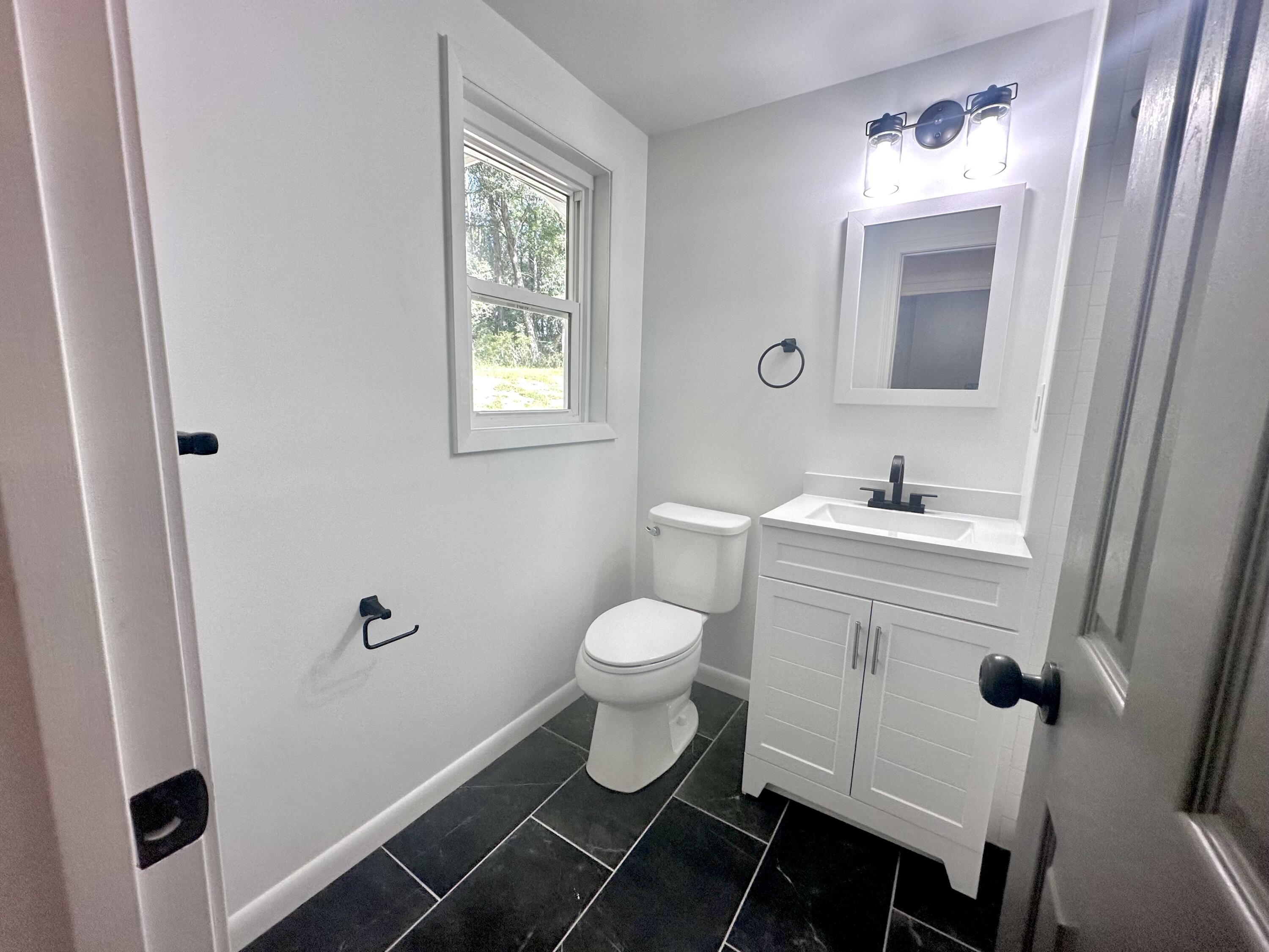 159 Smith Street Crestview, FL 32539 - Photo 21 of 29 a bathroom with a toilet sink and mirror