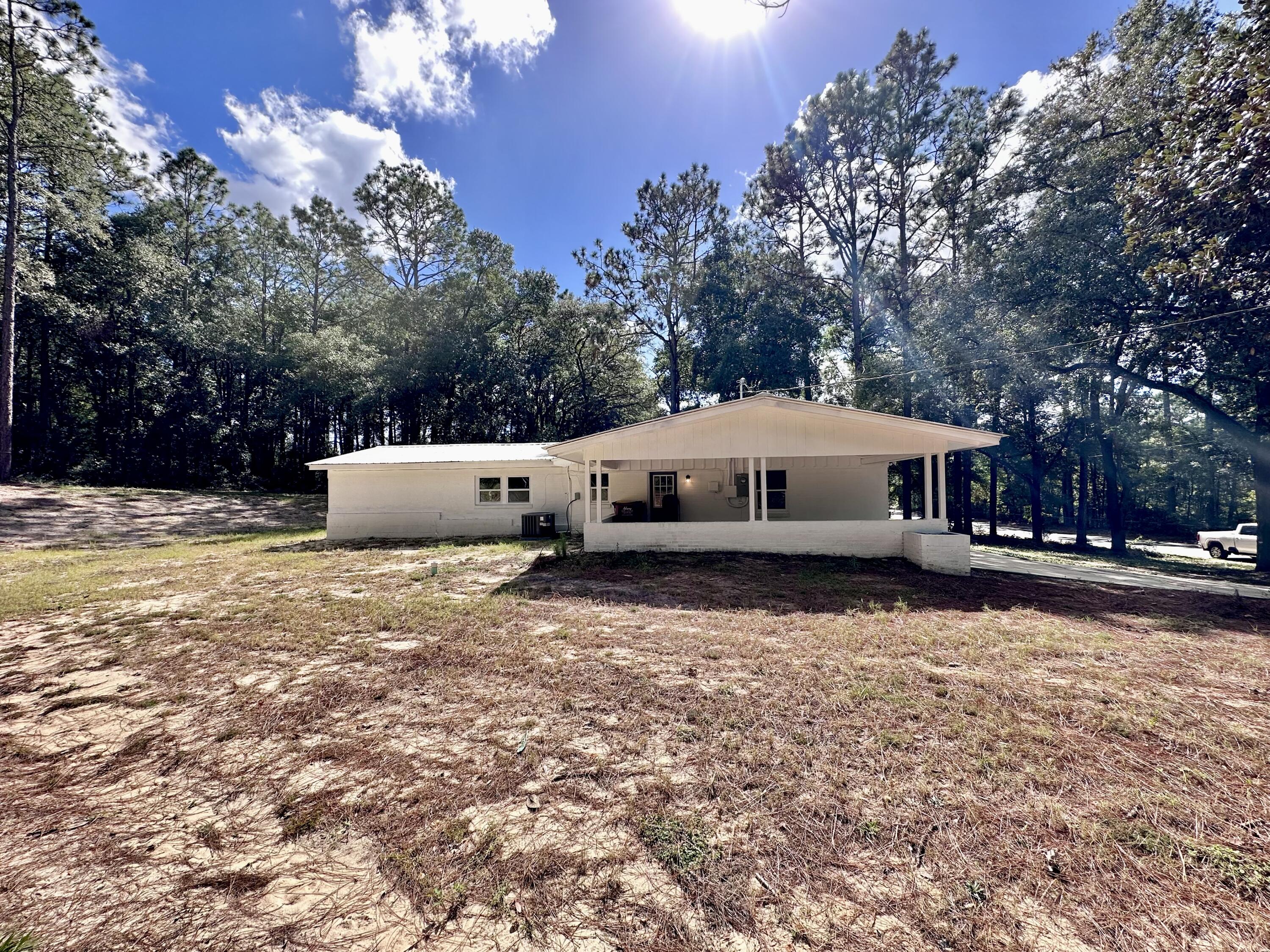 159 Smith Street Crestview, FL 32539 - Photo 24 of 29 a white house that has a tree in it