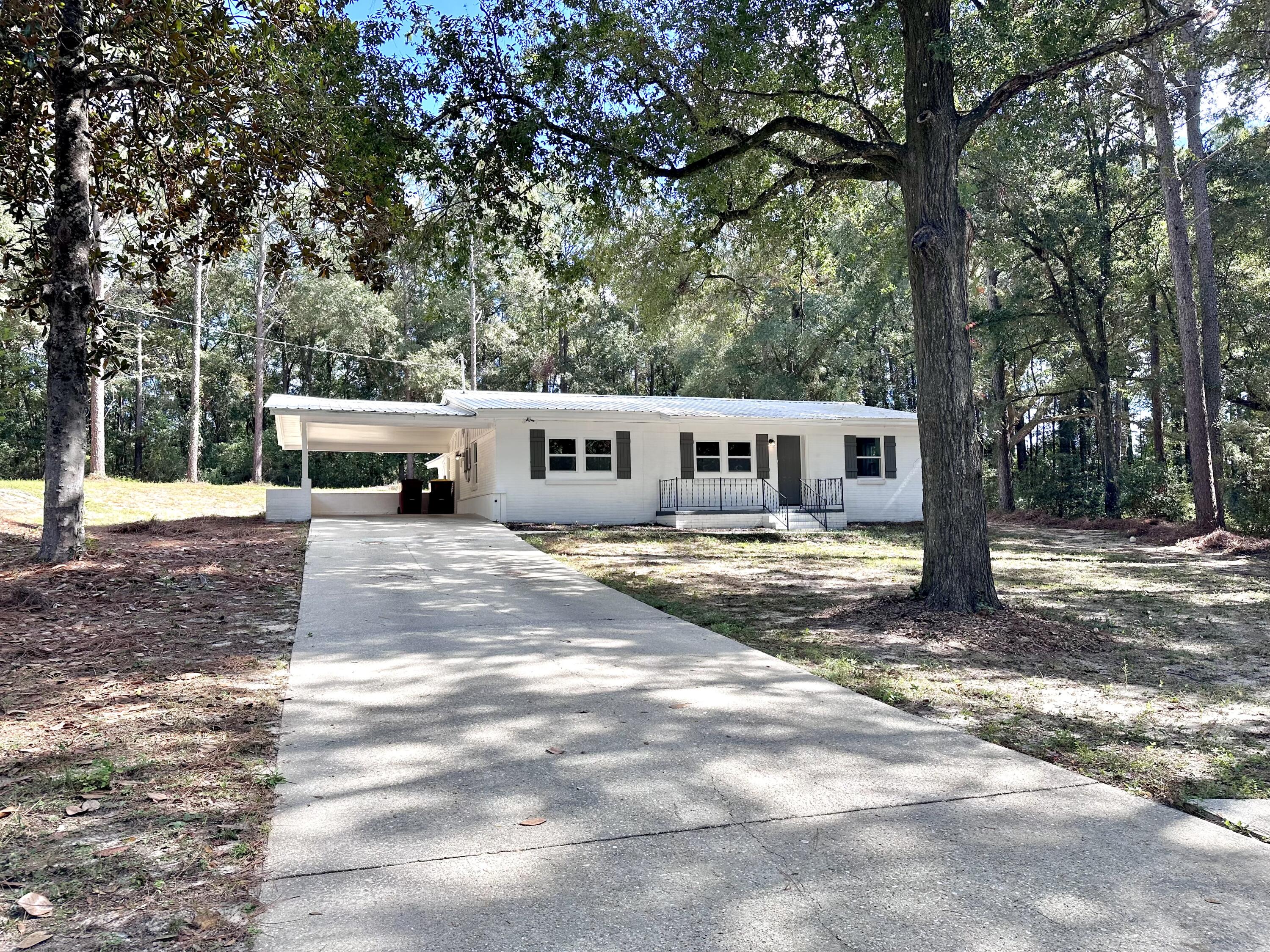 159 Smith Street Crestview, FL 32539 - Photo 3 of 29 a view of house with outdoor space and trees in the background