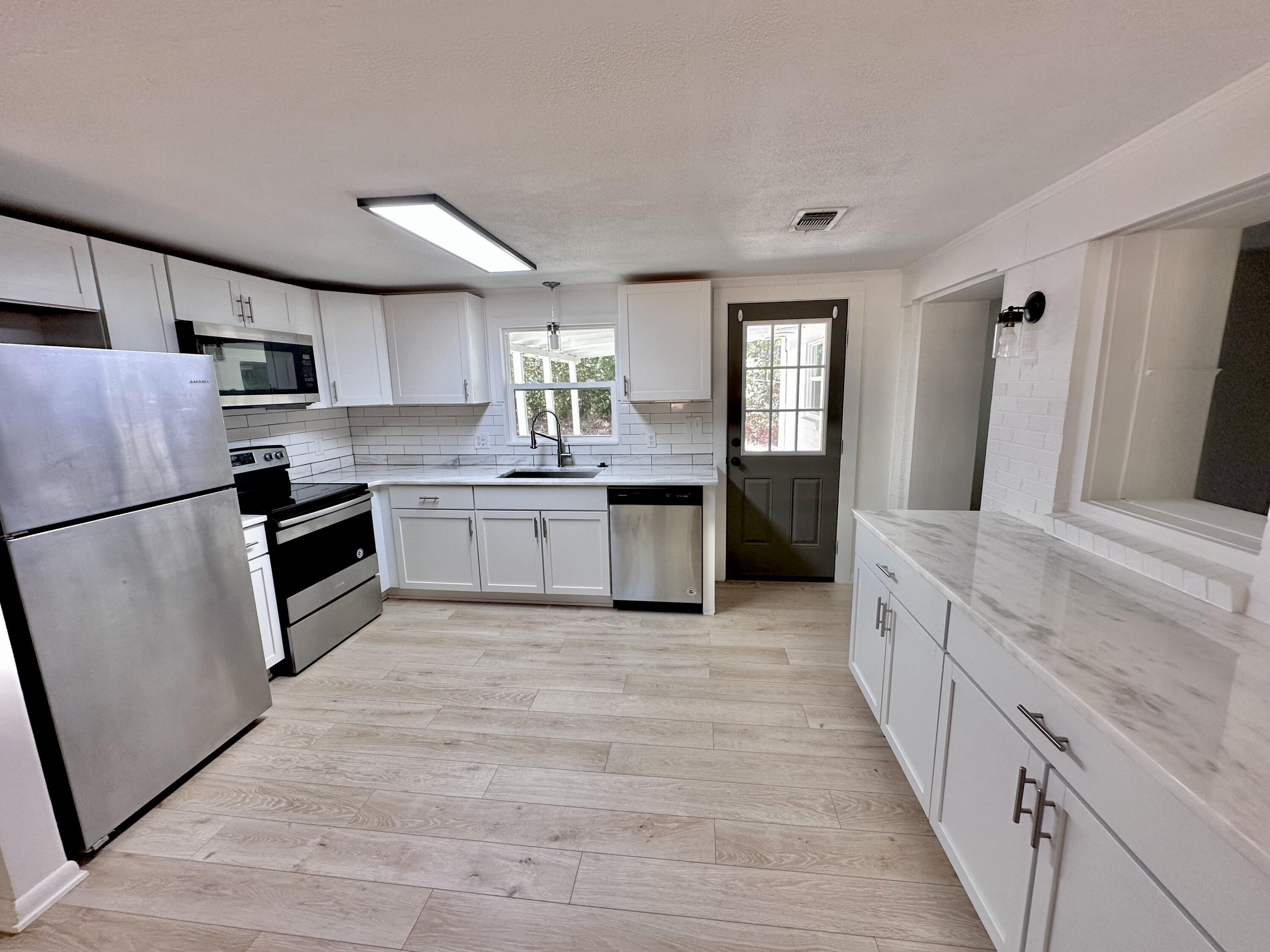 159 Smith Street Crestview, FL 32539 - Photo 5 of 29 a large kitchen with a stove and refrigerator