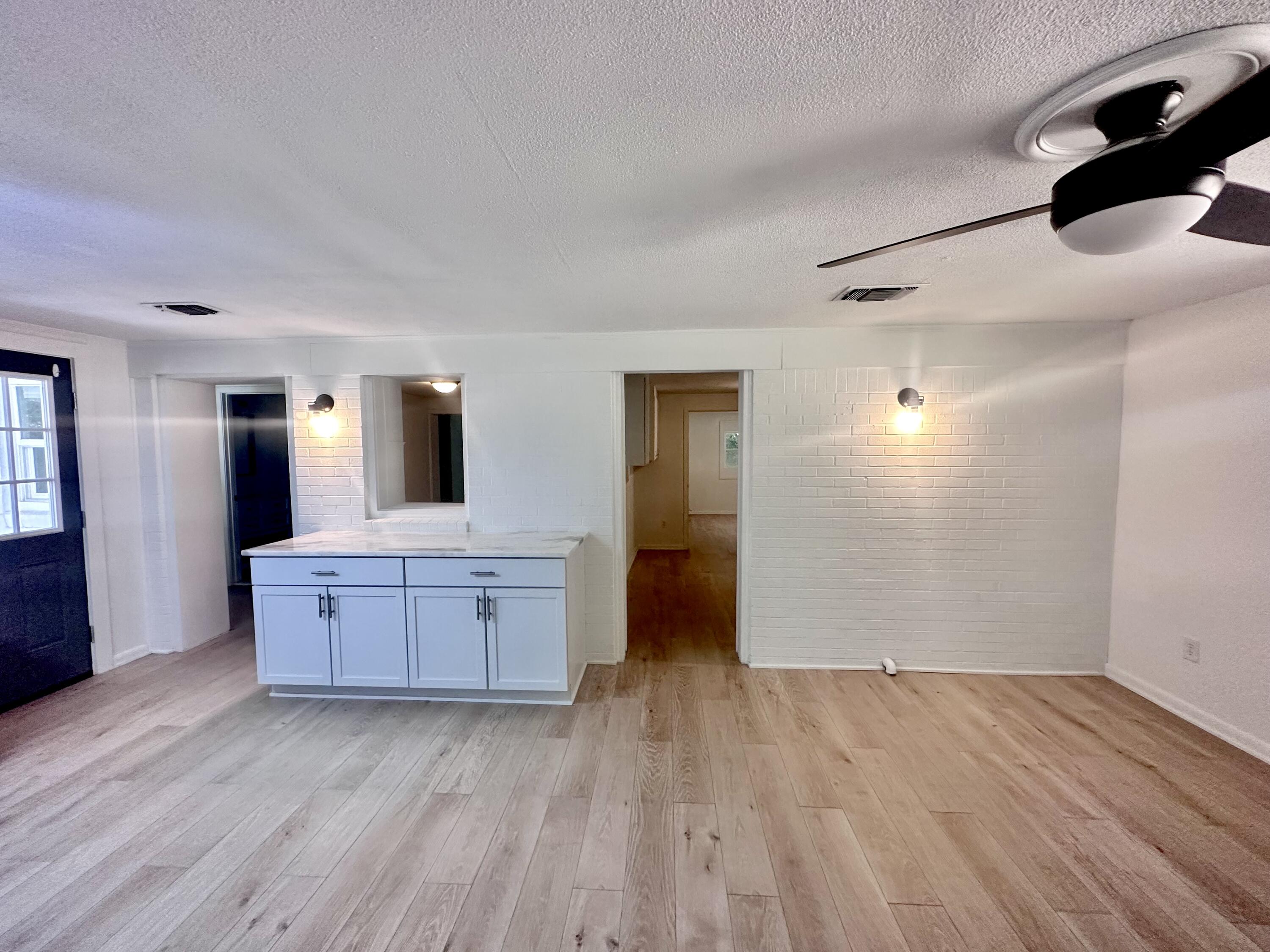 159 Smith Street Crestview, FL 32539 - Photo 7 of 29 a kitchen with a wooden floor and window