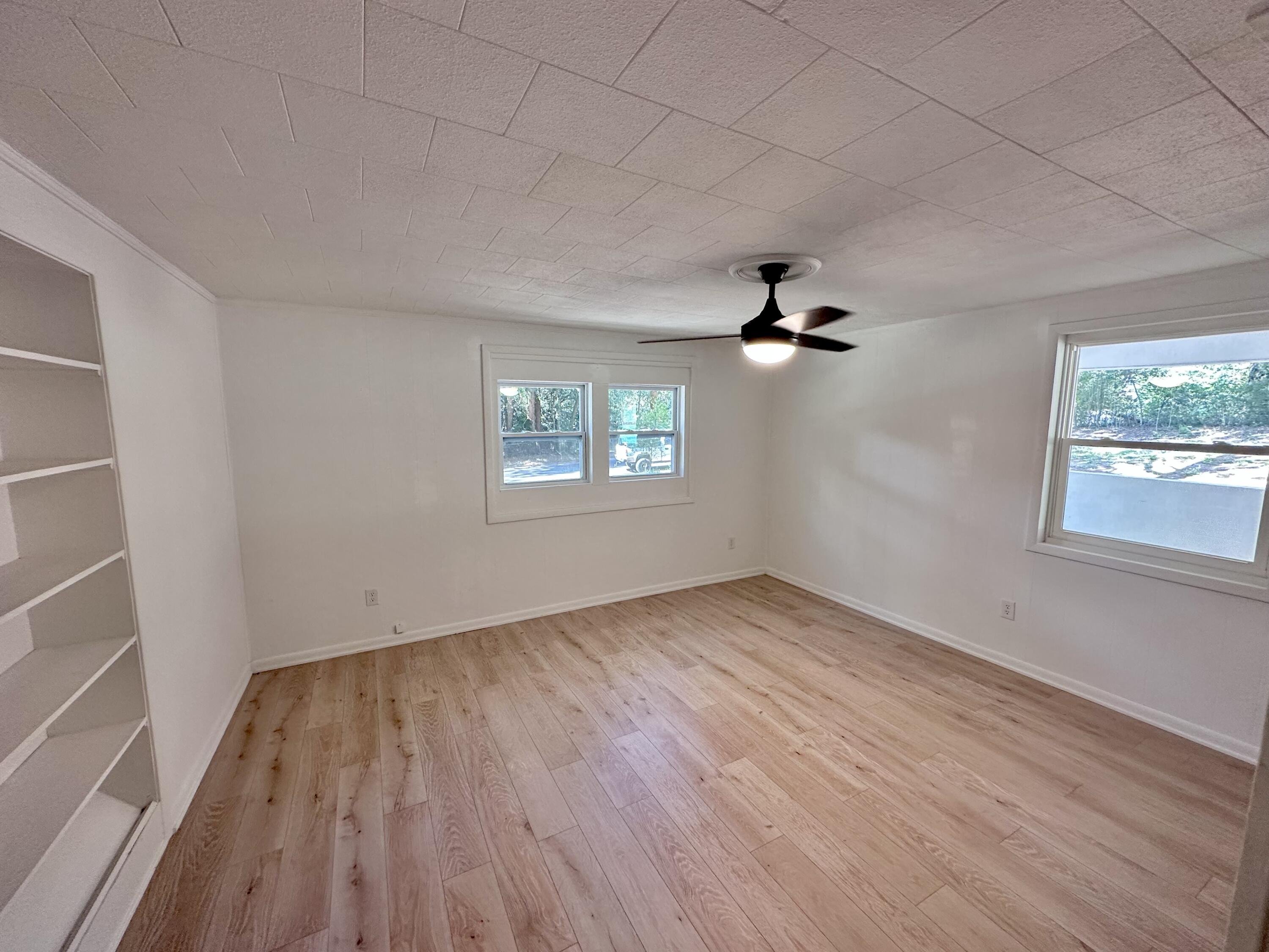 159 Smith Street Crestview, FL 32539 - Photo 10 of 29 wooden floor in an empty room with a window