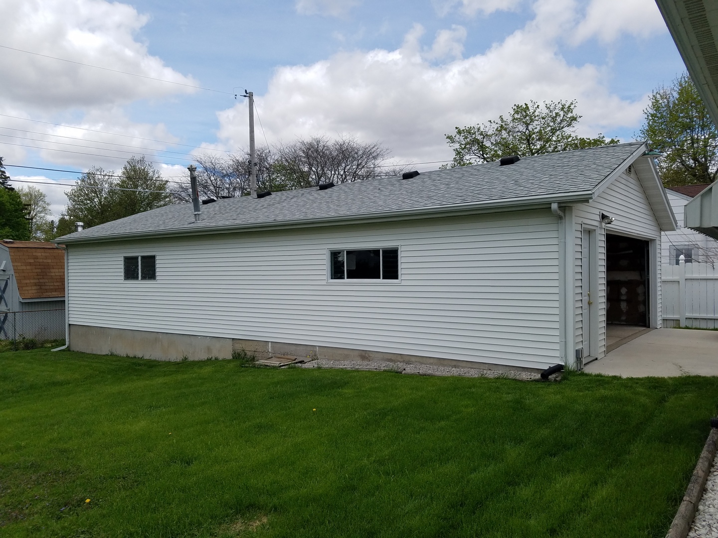 950 North 12th Street Rochelle, IL 61068 - Photo 2 of 18 a view of a backyard with plants and a large tree