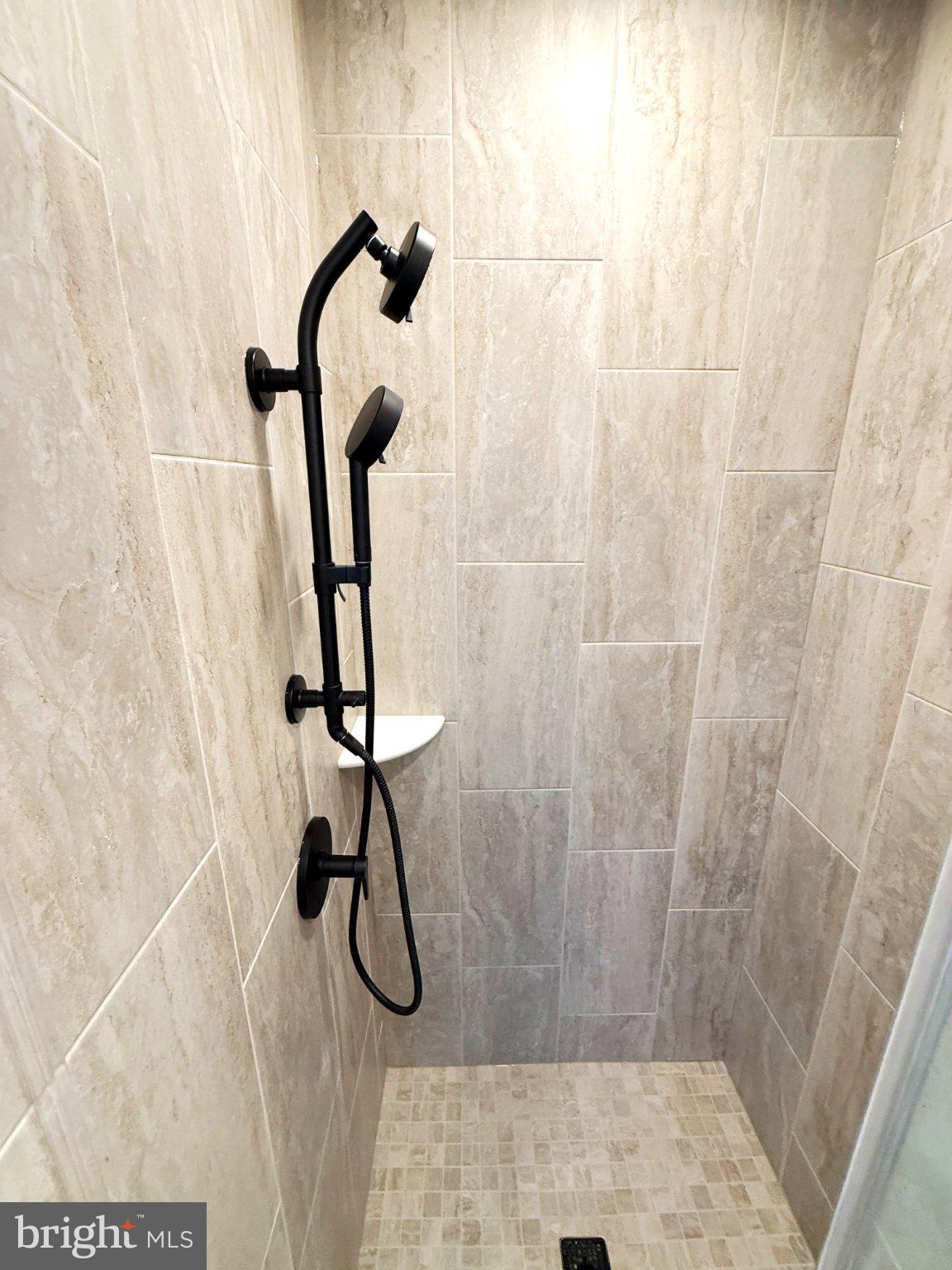 33 Lower Service Court Northwest Washington, DC 20001 - Photo 45 of 51 Sleek modern shower with elegant tiles.