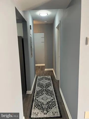 a view of hallway with wooden floor