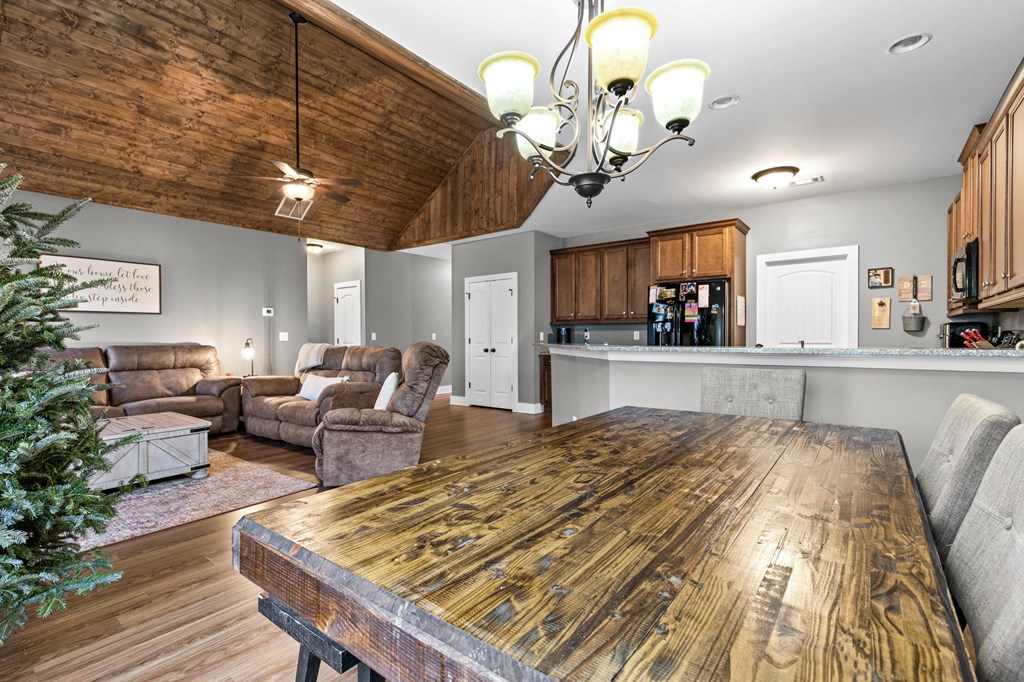 41 Brumby Trail Ellijay, GA 30536 - Photo 16 of 39 a spacious bedroom with a bed a chandelier and couch