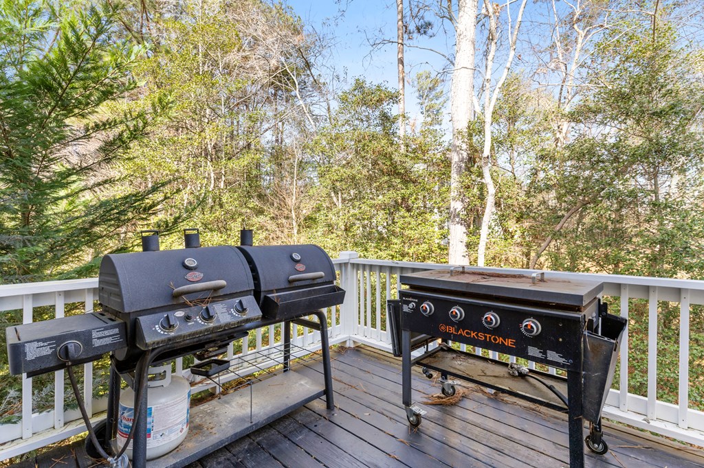 41 Brumby Trail Ellijay, GA 30536 - Photo 17 of 39 a view of a roof deck with wooden chairs and a table
