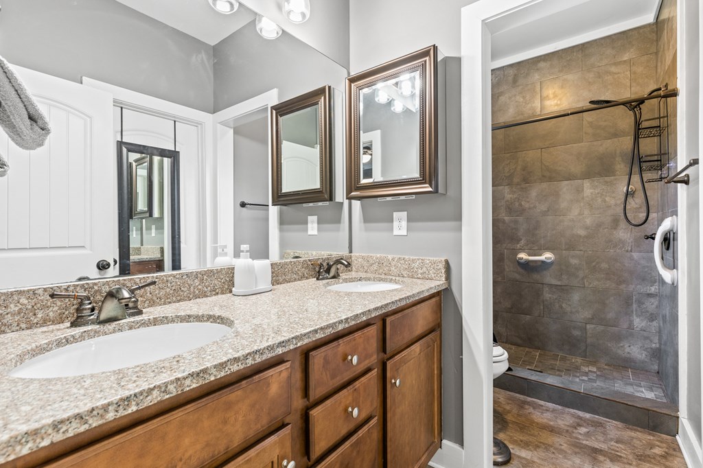 41 Brumby Trail Ellijay, GA 30536 - Photo 30 of 39 a bathroom with a granite countertop sink a mirror and shower