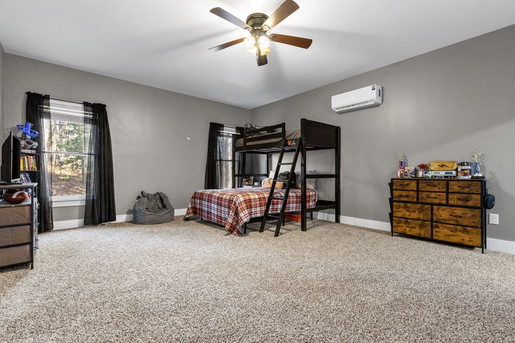 41 Brumby Trail Ellijay, GA 30536 - Photo 37 of 39 a bedroom with furniture and a chandelier