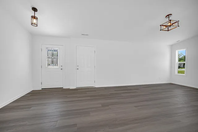a view of kitchen with wooden floor window and stainless steel appliances