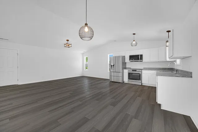 a bathroom with a sink a toilet and a large mirror