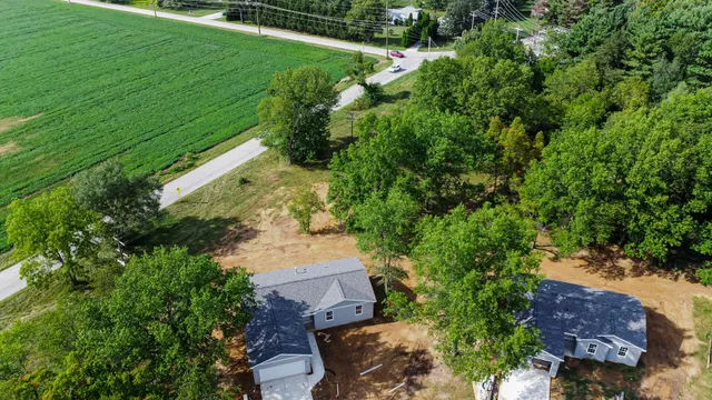 an aerial view of a house with a garden and lake view