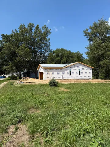 a large house with a large tree in front of it