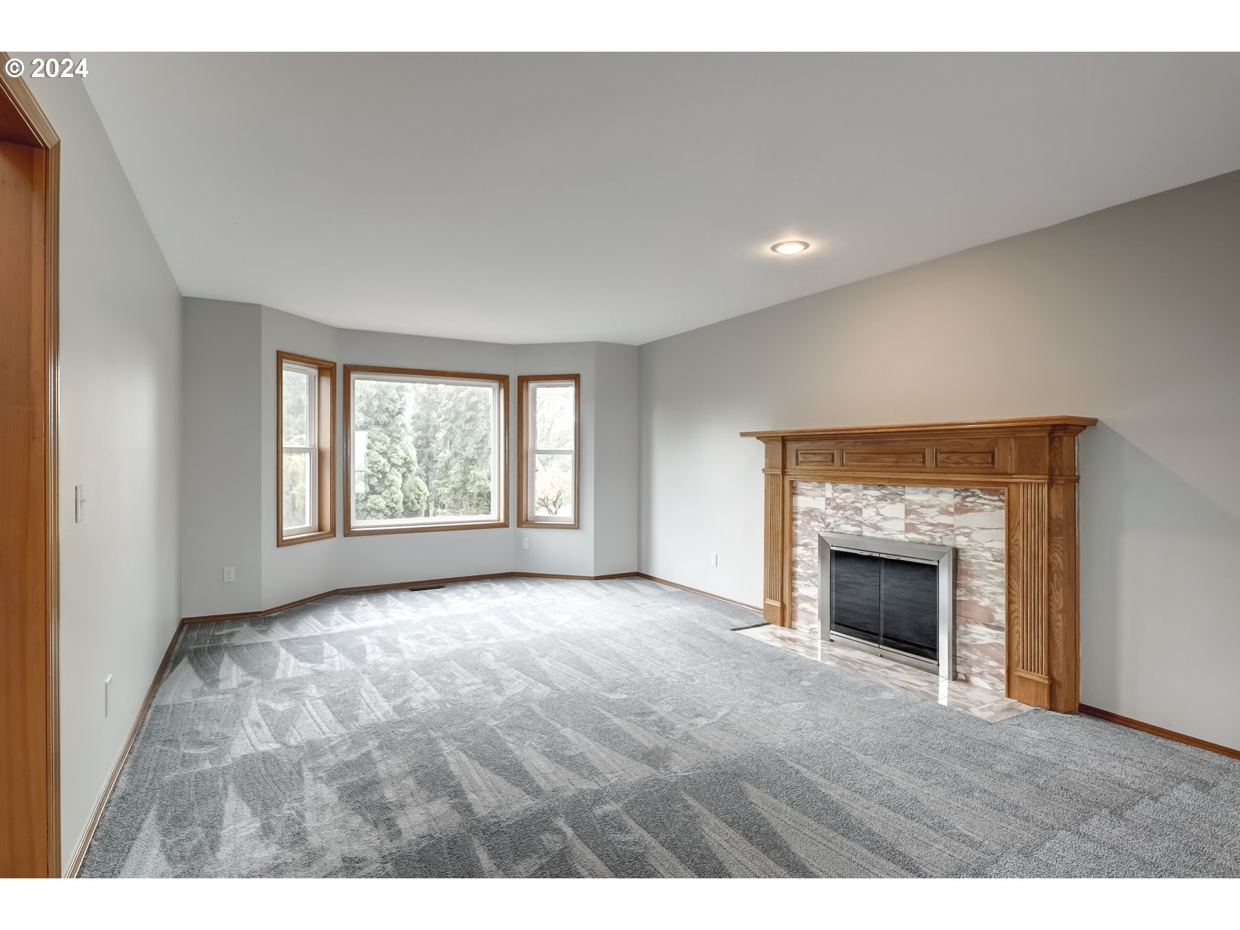 33495 Southwest Riedweg Road Cornelius, OR 97113 - Photo 6 of 48 a view of an empty room with a fireplace and a window