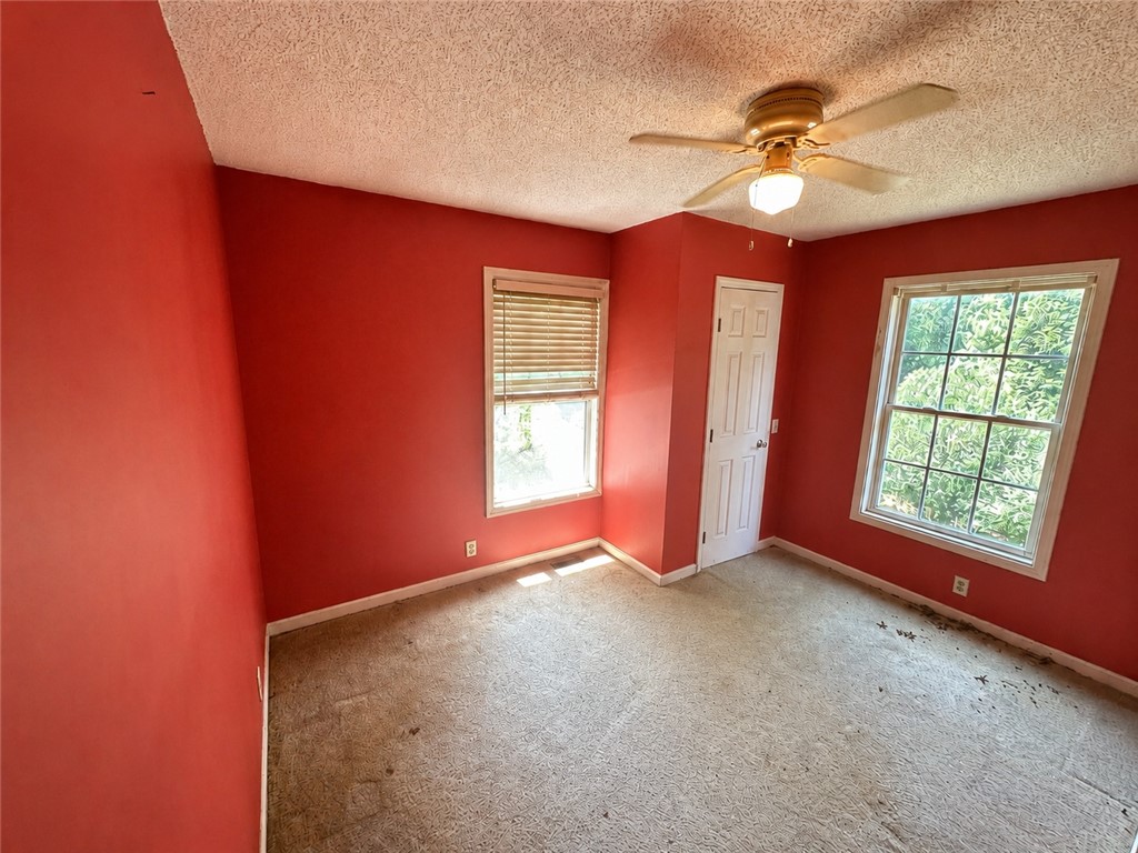 138 Cloverdale Road Seneca, SC 29678 - Photo 11 of 27 A comfortable bedroom with a ceiling fan and abundant natural light.