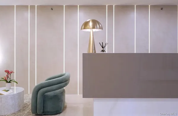a living room with furniture and a lamp