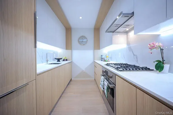a large kitchen with a stove and a sink