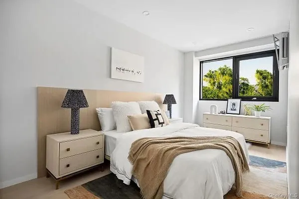 a bedroom with a bed and a large window