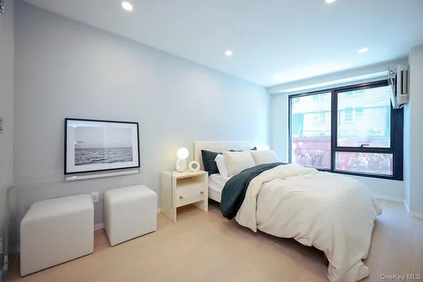 a bedroom with bed and a large window