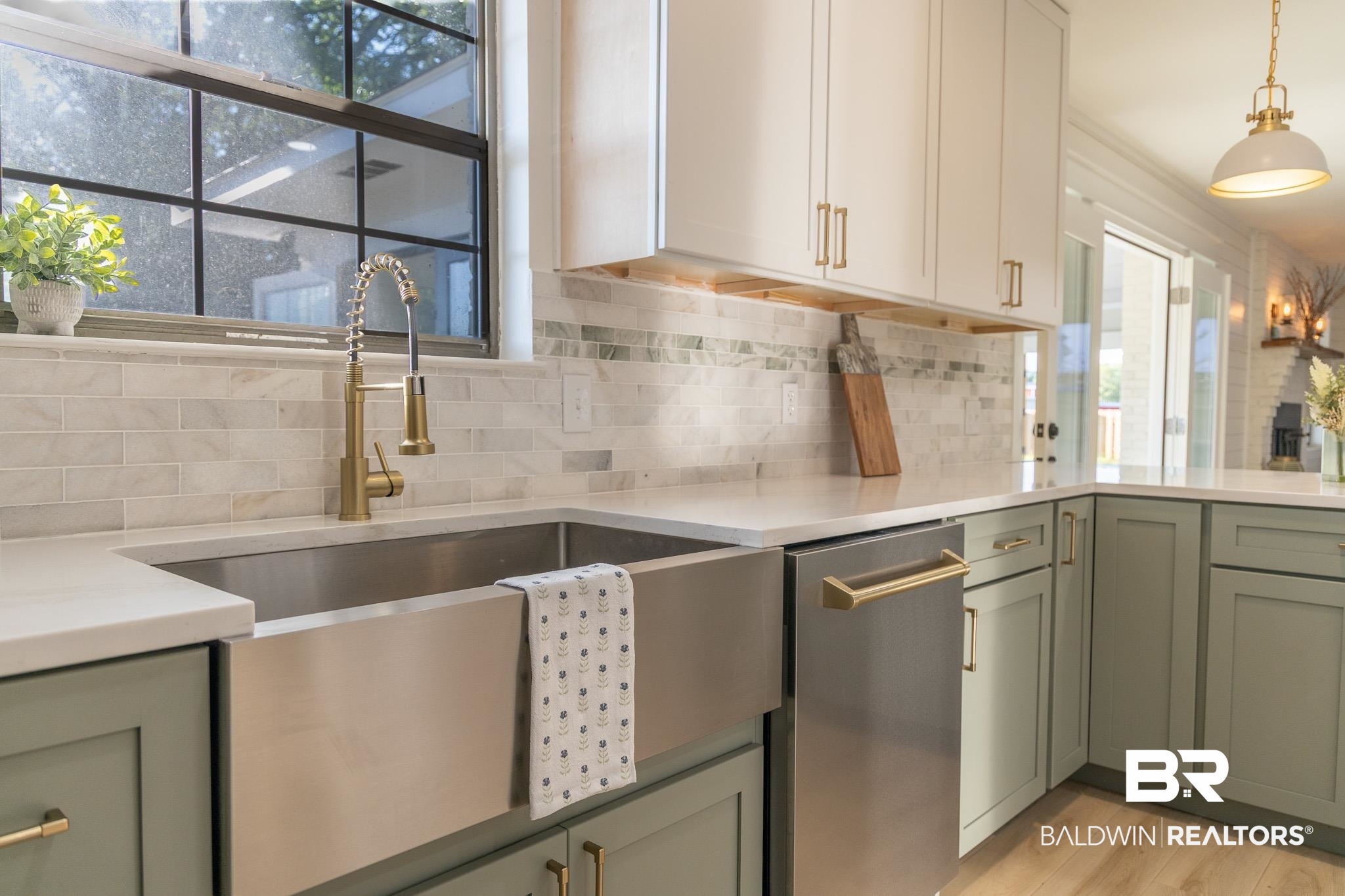 19690 Lawrence Road Fairhope, AL 36532 - Photo 19 of 73 Kitchen featuring stainless steel dishwasher, backsplash, light countertops, a sink, and light wood finished floors