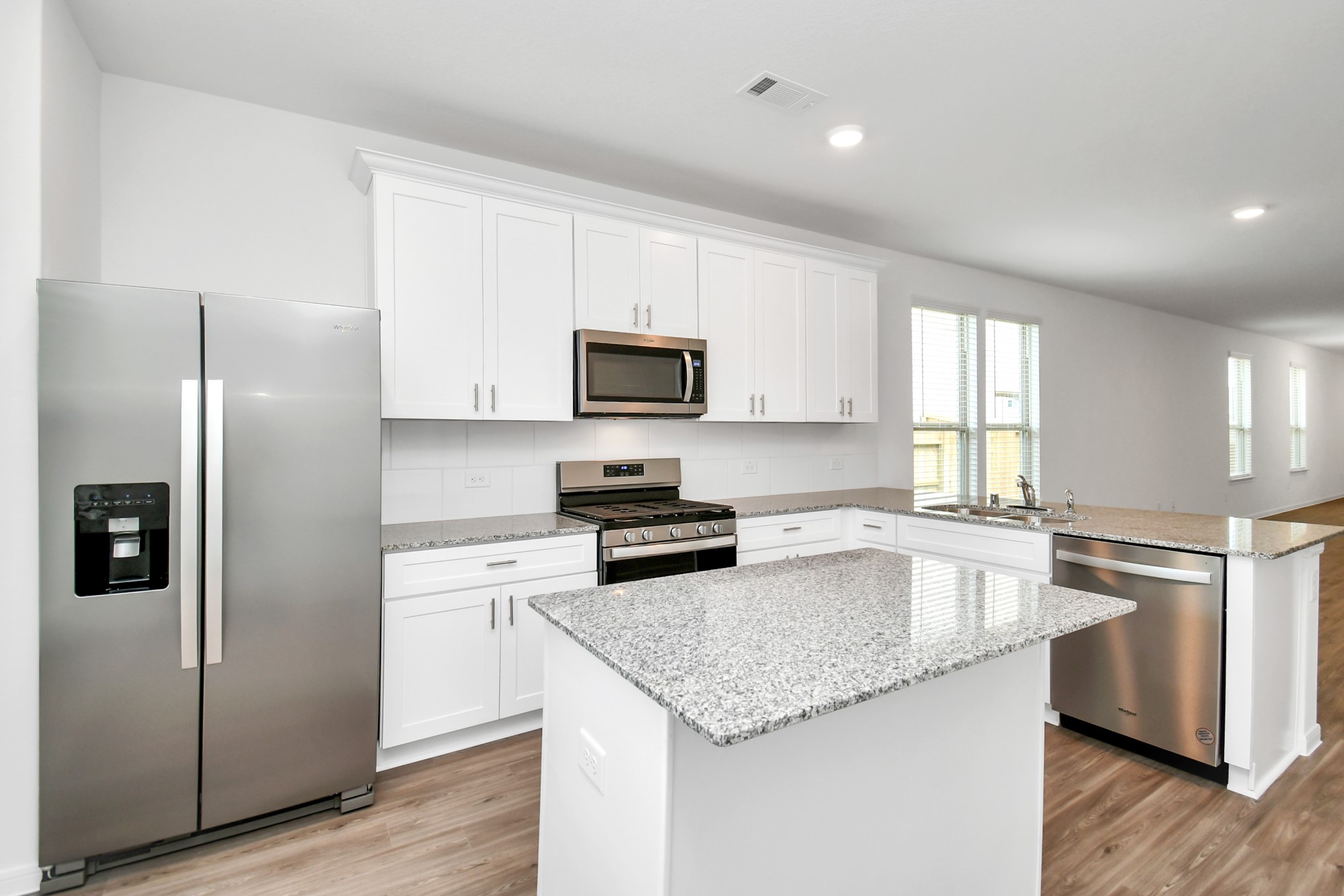 16150 Elbridge Court Conroe, TX 77302 - Photo 7 of 46 Kitchen fully equipped with stainless steel appliances including side-by-side refrigerator.